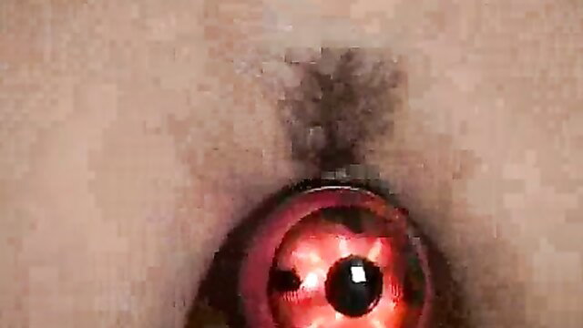 Brunette teen masturbates pussy with red light BDSM toy closeup