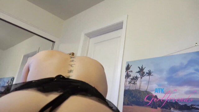 Hot Asian babe in black lingerie showing sexy tattooed back and ass