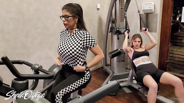Two fit women in sexy gymwear workout, lesbian heat builds