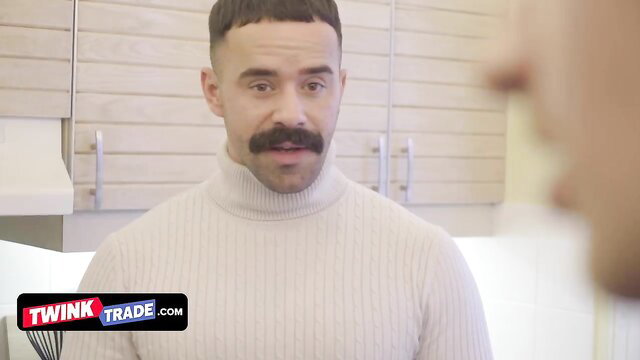Teddy Torres in turtleneck with mustache smirks naughtily