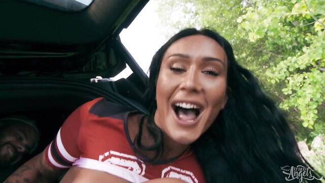 Bella Joie laughing in red crop top with Marcus McNeil in car