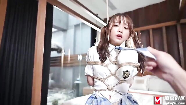 Japanese schoolgirl in shibari rope bondage, gagged, held by hand