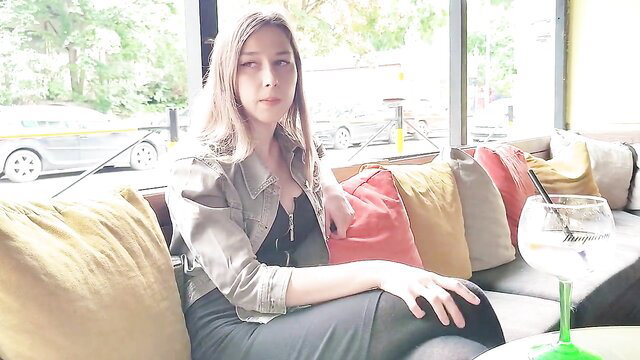 Blonde stepsister in denim jacket and dress sips gin at bar, remote orgasm tease