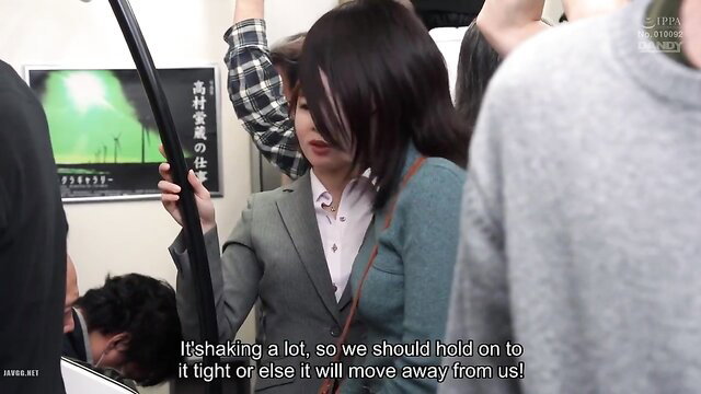 Crowded JAV train with black-haired office lady gripping strap tightly