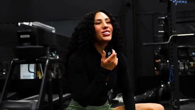 Curvy black fitness babe smiling in tight gym outfit, heavy lift workout