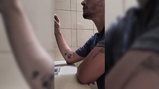 Super sexy tattooed guy with beard smoking post-workout