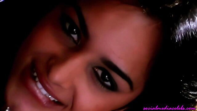 Closeup of smiling beautiful Desi influencer with dark eyes and glossy lips