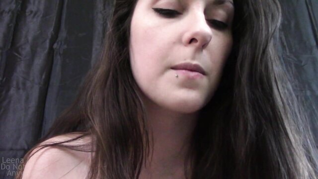 Leena Mae closeup face, dark wavy hair, bare shoulders, seductive gaze