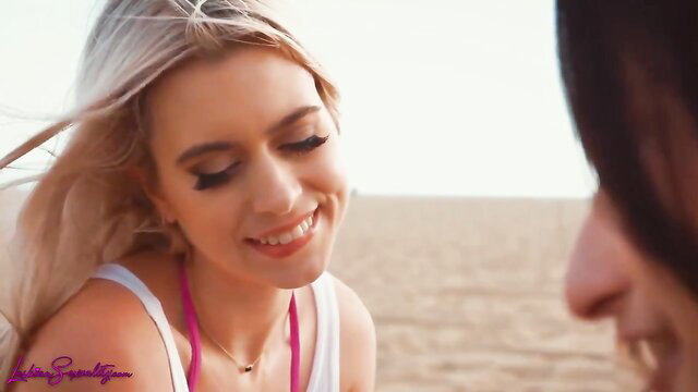 Blonde Jill Kassidy smiles seductively at beach with Isabella Nice