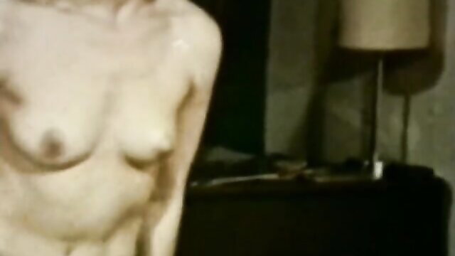 Nude pale blonde bombshell with big tits in classic XXX scene