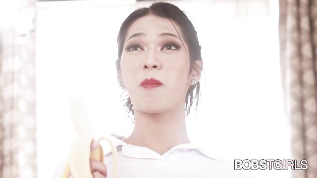 Asian trans girl with banana, seductive gaze in white shirt Bobs TGirls