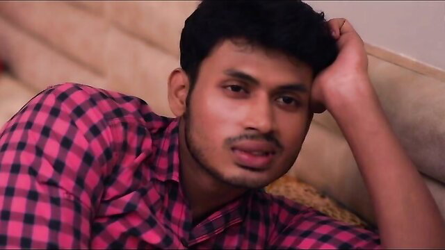 Handsome Indian man in checkered shirt poses seductively