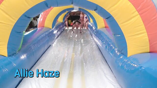 Allie Haze and hot blondes sliding down wet inflatable water slide in bikinis