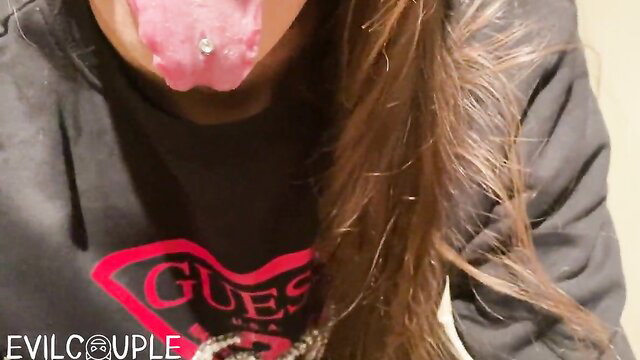 Amateur girl with tongue piercing sticks out tongue in Guess hoodie, public BJ tease