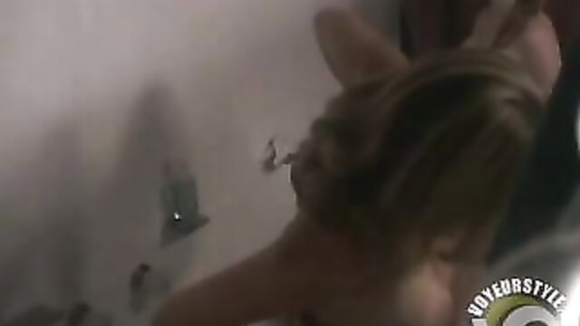 Brunette with big tits showers nude, water streams on curves