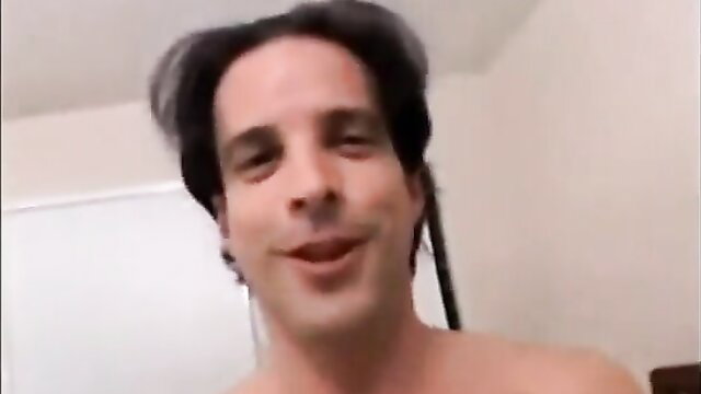 Shirtless Latino man smiling in 'Gotta Pay Rent' adult video thumbnail