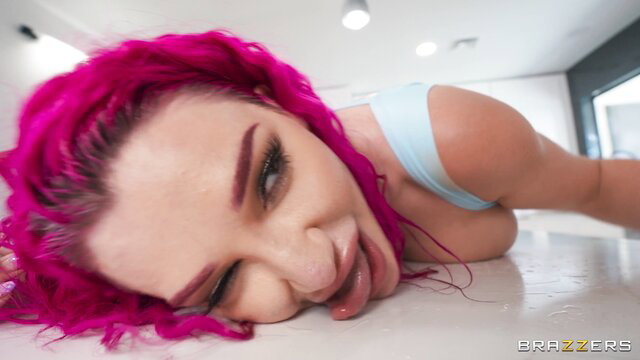 Lily Lou pink-haired beauty tongue out in erotic pose
