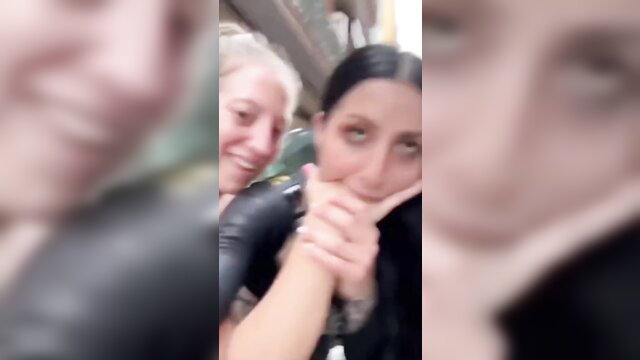 Blurry selfie of two women in leather jackets on public train