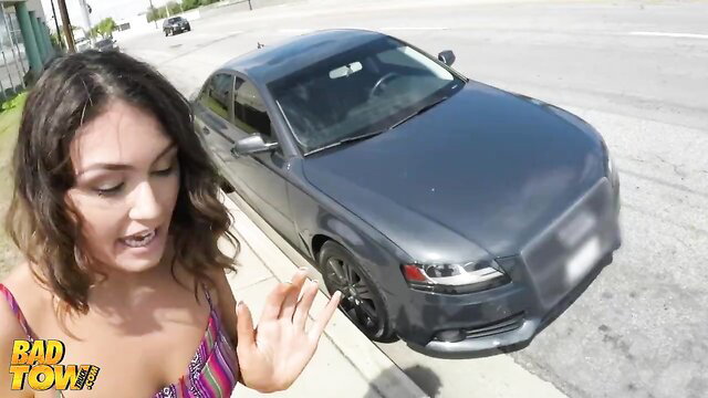 Brunette in skimpy top flirts with tow truck driver by Audi