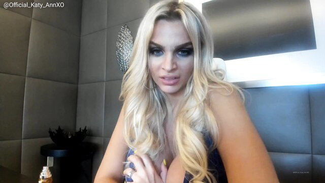 Blonde Kat with big tits in tight dress, seductive pose