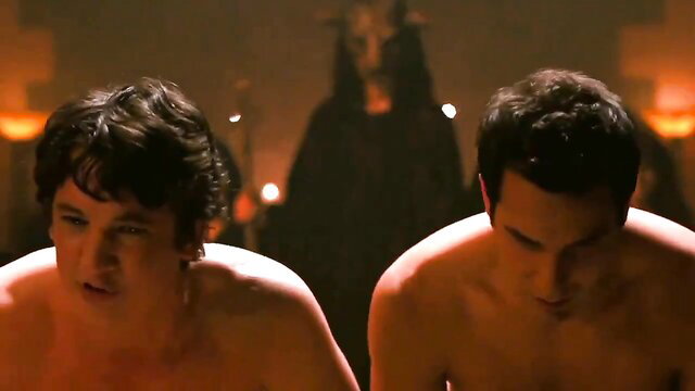 Two nude young men kneeling before demonic figure in ritual scene