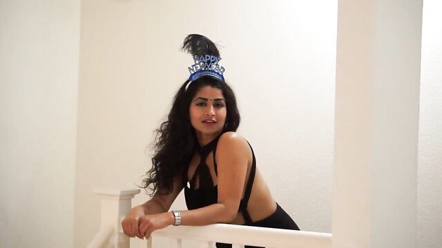 Desi Bhabhi Maya Rati in sexy black dress with slit and New Year hat