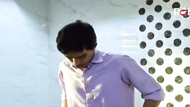 Handsome young Indian man in light purple shirt, closeup portrait