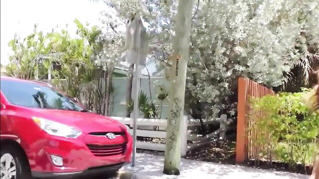 Brunette MILF in dress by red car in outdoor interracial tease