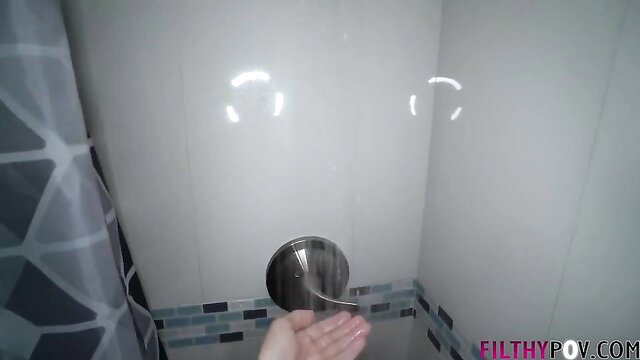 Russian skinny teen holds showerhead in steamy bathroom POV