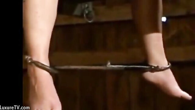 Sexy MILF legs shackled in chains during BDSM torture