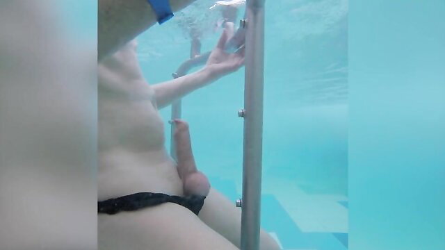 Nude man in Speedo enjoys water jet on cock in pool enclosure