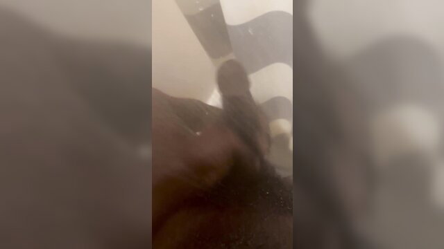 Blurry closeup of black man stroking thick cock in intense solo masturbation