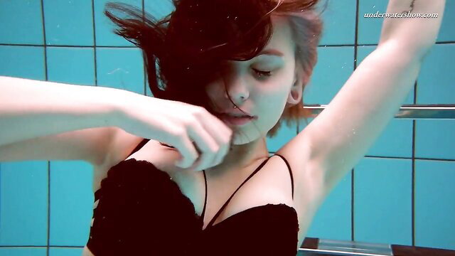 Beautiful teen in black lace bra underwater, wet red hair floating sensually