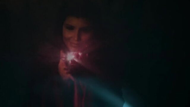 Mystery brunette holds glowing red toy in dark erotic tease, Queen of Thrones XXX parody