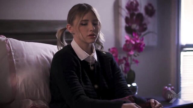 Melody Marks in schoolgirl uniform on bed, soft lighting