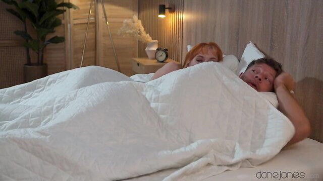 Lilly Mays redhead in bed with man under sheets, Dane Jones