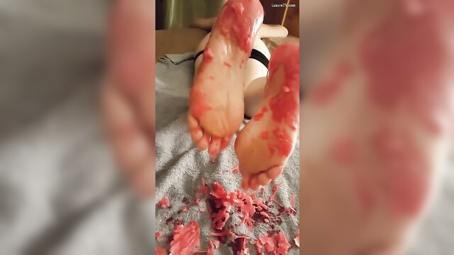 Girlfriend's bare soles dripping with red candle wax in fetish tease
