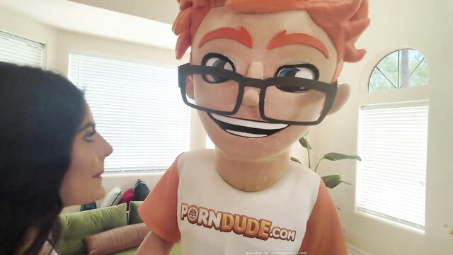 Angel Gostosa with PornDude mascot in teasing handjob scene