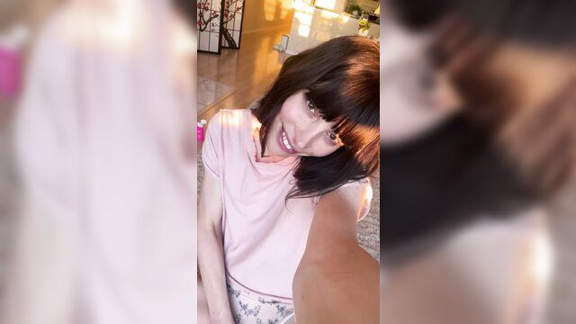 Haven Mayyy post-op tgirl smiles in pink top, tiny joy in sunset selfie