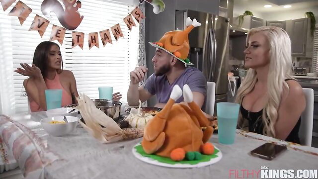 Blonde and ebony babes with guy in Thanksgiving fetish threesome