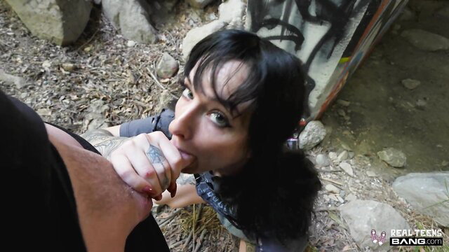 Tattooed teen with black pigtails sucks cock outdoors in wild