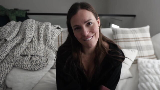 Yogabella smiling on bed in black top, seductive amateur thumbnail