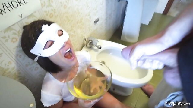 Masked brunette Morgan drinks piss from glass in Bruce toilet filth scene