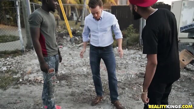 Mr. BWC in white shirt talks with two black men outdoors - Gina Valentina scene