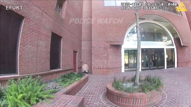 Blurry figure caught on police bodycam outside brick building in eFukt compilation