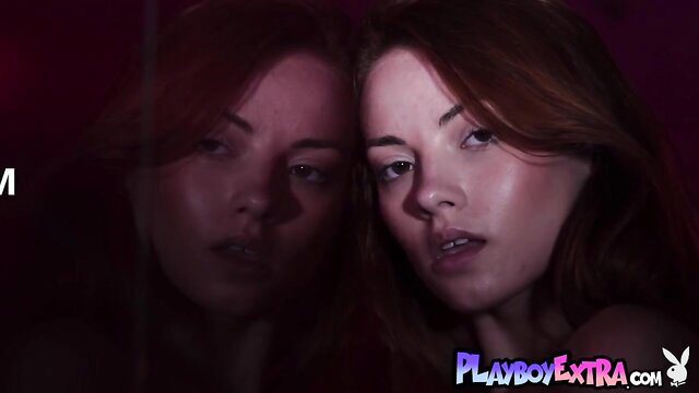 Redhead babe with sultry gaze in mirror reflection Playboy extra