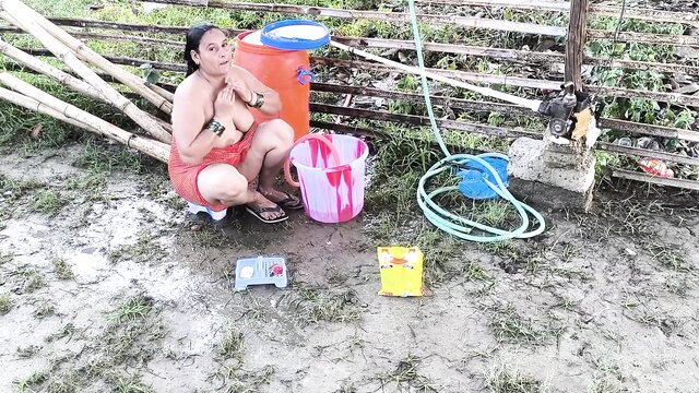 Topless Filipina beauty bathing outdoors with huge tits exposed