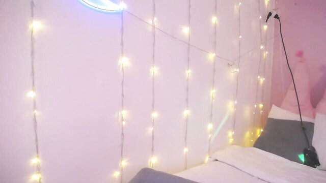 Amateur big tits girl in pink bedroom with fairy lights