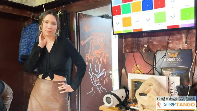 Hot brunette in black blouse and leather skirt teases on cam at stripTango