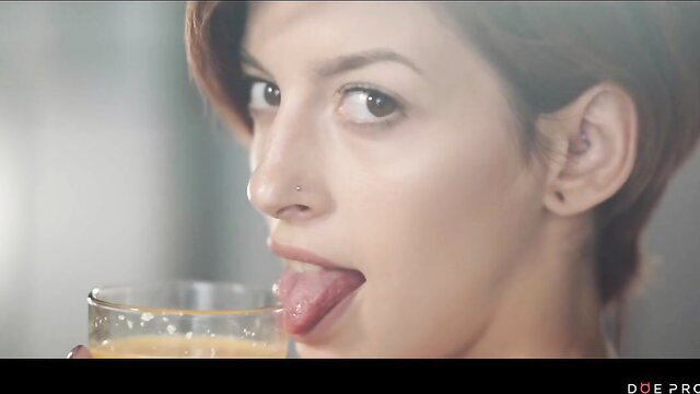 Caomei Bala sticks out tongue licking orange juice glass sensually